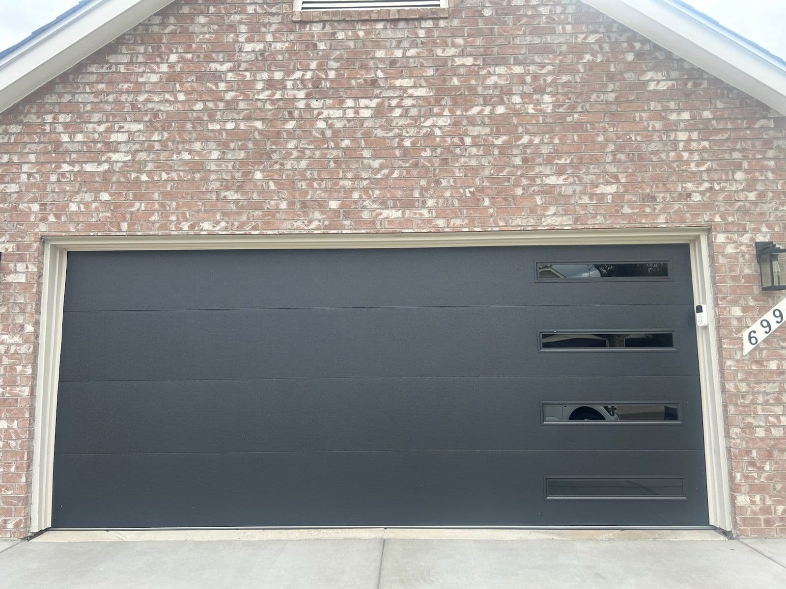 Project Sleek Black Garage Door with Modern Touch image